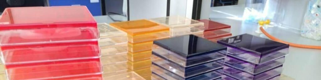 A stack of colourful SBS plates containing agar with different concentrations of antimicrobials, ready to be used to determine the minimum inhibitory concentration.